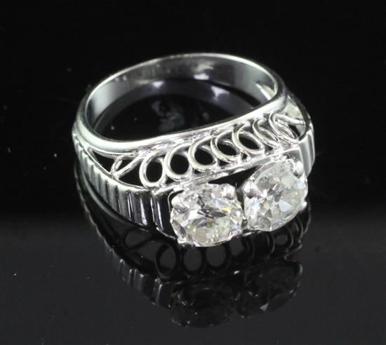 A mid 20th century French 18ct gold, platinum and two stone diamond ring, size P.